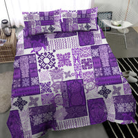 Purple and white patterned quilt set with matching pillowcases, patchwork squares and tiles