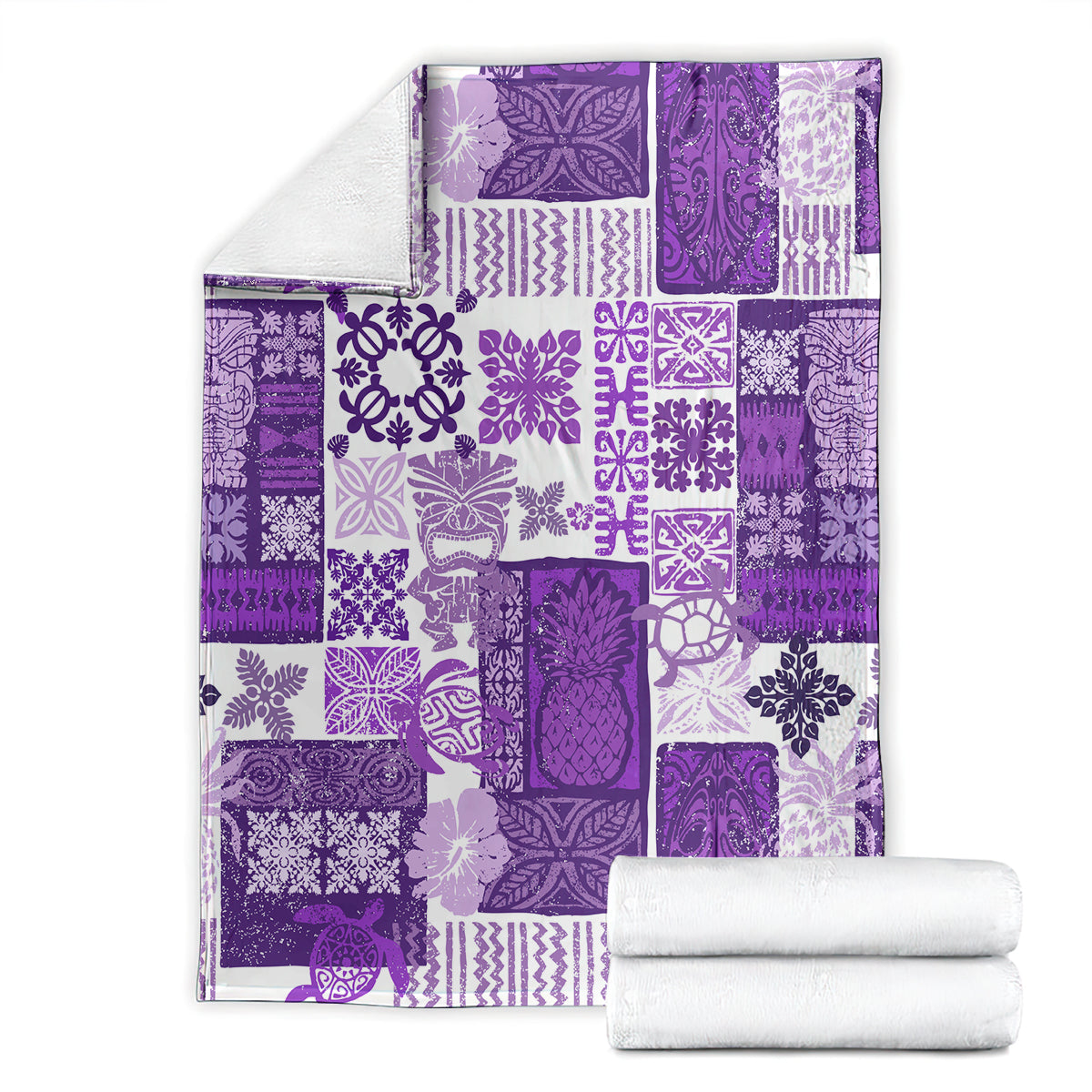 Purple tiki patchwork quilt blanket with folded corners; white towels stacked beside it