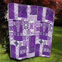 Purple and white patchwork quilt with repeating decorative floral tile blocks