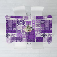 Purple patchwork tiki tablecloth laid flat, collage of geometric motifs.