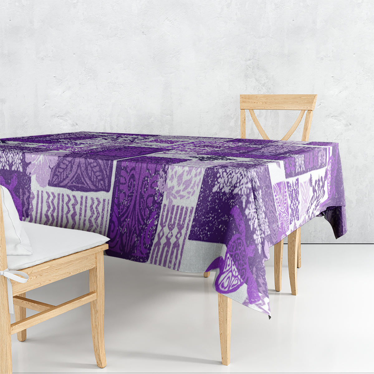 Purple quilt-style tablecloth with patchwork tropical motifs and patterned border.