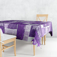 Purple quilt-style tablecloth with patchwork tropical motifs and patterned border.
