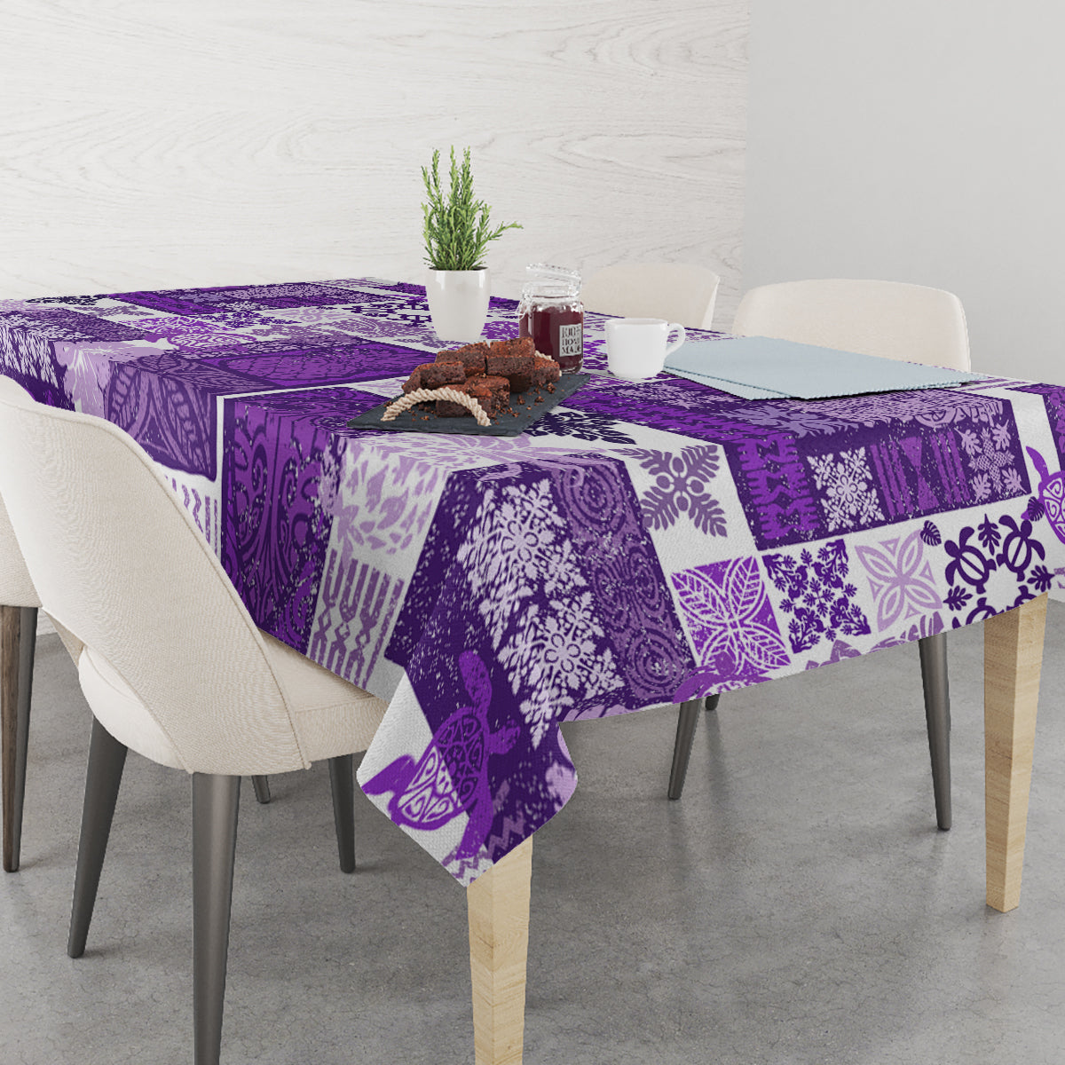 Purple quilt-style tablecloth with tiki and geometric patchwork patterns.