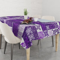 Purple quilt-style tablecloth with tiki and geometric patchwork patterns.
