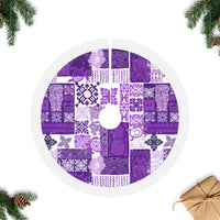 Purple quilt tree skirt with tiki patchwork and white ruffled edge around center hole
