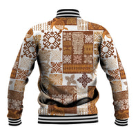 Quilt baseball jacket with brown-and-tan patchwork, ribbed hem and black/white striped cuffs.