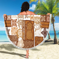 Round tiki patchwork beach blanket in brown and white, spread out with fringe