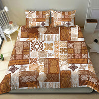 Brown and tan tiki patchwork quilt bedding set with two pillowcases on bed