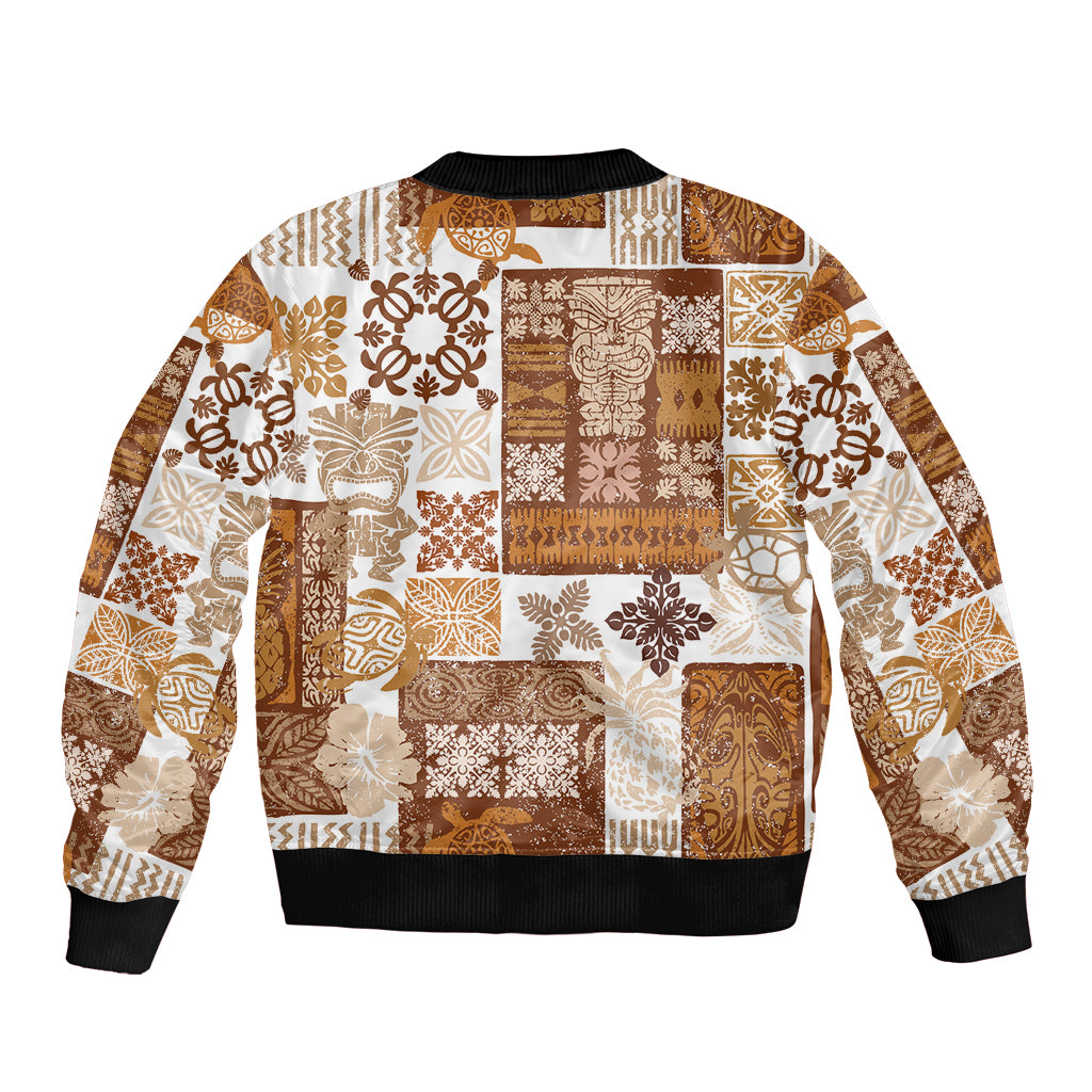 Unisex bomber jacket with brown-and-cream tiki patchwork quilt print, ribbed hem and cuffs