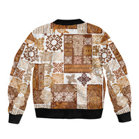 Unisex bomber jacket with brown-and-cream tiki patchwork quilt print, ribbed hem and cuffs