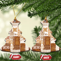 Brown quilt-style ceramic Christmas tree ornament held in hand with gold string