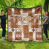 Brown patchwork quilt with white and tan geometric tiki and floral squares