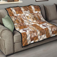 Brown and white patchwork quilt with tiki and floral motifs on a sofa