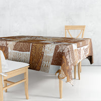 Brown quilt-style tablecloth corner with patchwork tiki and geometric motifs