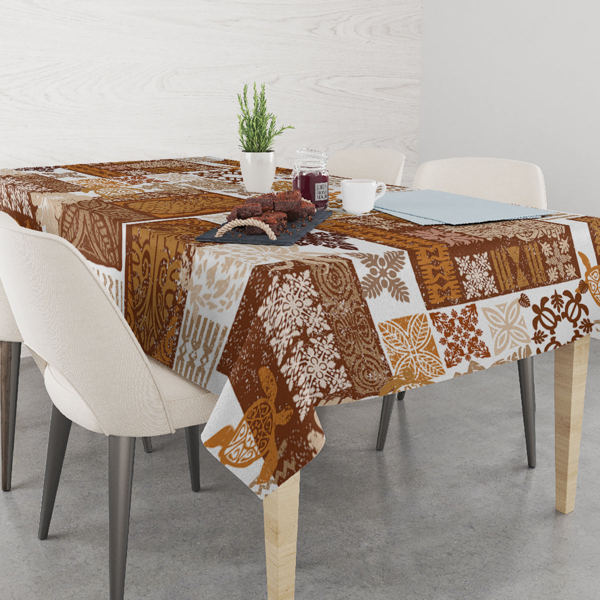 Brown quilt-style tablecloth draped on dining table with patchwork tiki motifs