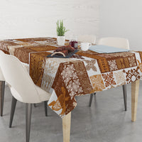 Brown quilt-style tablecloth draped on dining table with patchwork tiki motifs