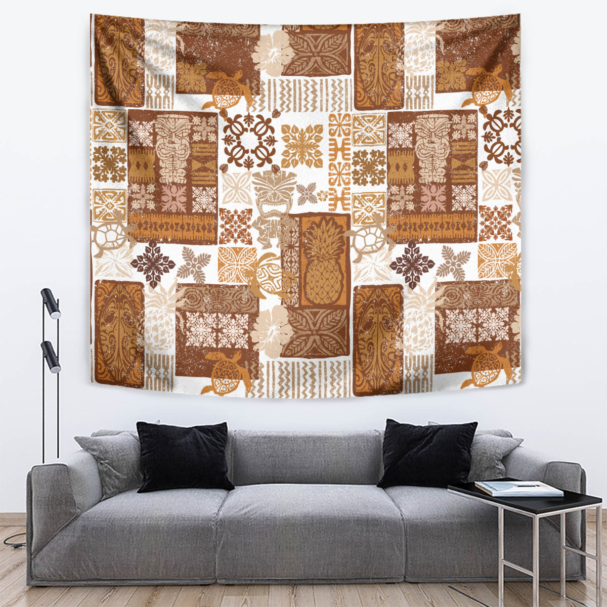 Brown tropical patchwork quilt tapestry showing tiki motifs, florals, and patterned panels; hanging