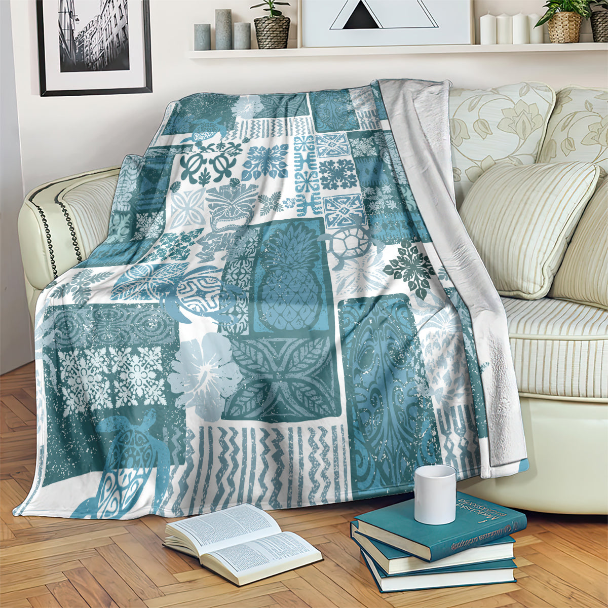 Dark cyan quilt blanket with white patterned blocks and tropical leaf motifs