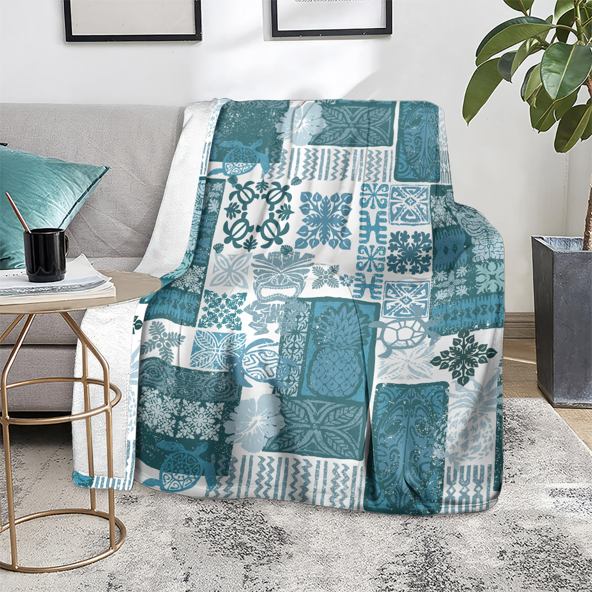 Teal patchwork quilt blanket with white tropical pattern squares and textured motifs