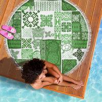 Round green tiki quilt beach blanket with white patch blocks and fringed edge