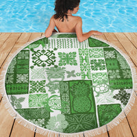 Green and white tiki-pattern round blanket with white fringe edge