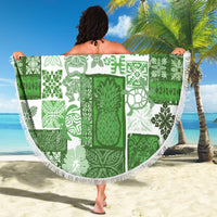 Green and white round tiki beach blanket with white fringe, held up
