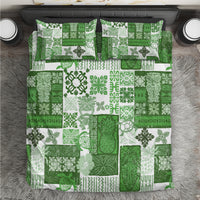 Green quilt bedding set with patchwork tropical leaf/geometric pattern and two matching pillows