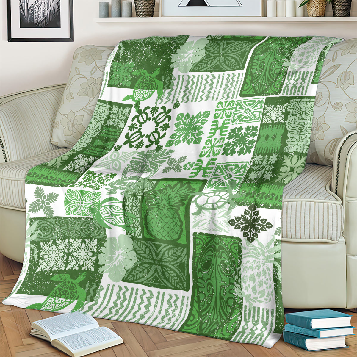 Green patchwork quilt blanket with tiki and leaf patterns, spread over a couch.