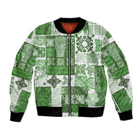 Green patchwork bomber jacket with tiki tropical print, full-zip front, ribbed cuffs