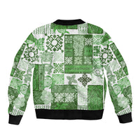 Green patchwork bomber jacket with tiki tropical print, ribbed hem and cuffs