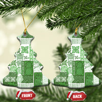 Green patchwork ceramic Christmas tree ornament with gold hanging loop hanging on tree branches