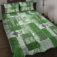 Green quilt bed set with white tiki leaf patchwork, black-trim pillows and black piping