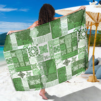 Green patchwork quilt sarong with tiki-style motifs, wide wrap fabric