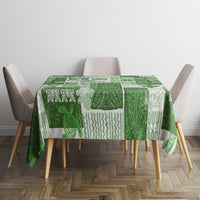 Green tiki patchwork tablecloth with repeating patterns on a dining table with chairs