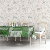 Green tiki patchwork tablecloth with mixed geometric and floral motifs on a table