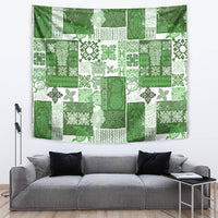 Green tropical quilt-style tapestry with patchwork tiki and floral patterns
