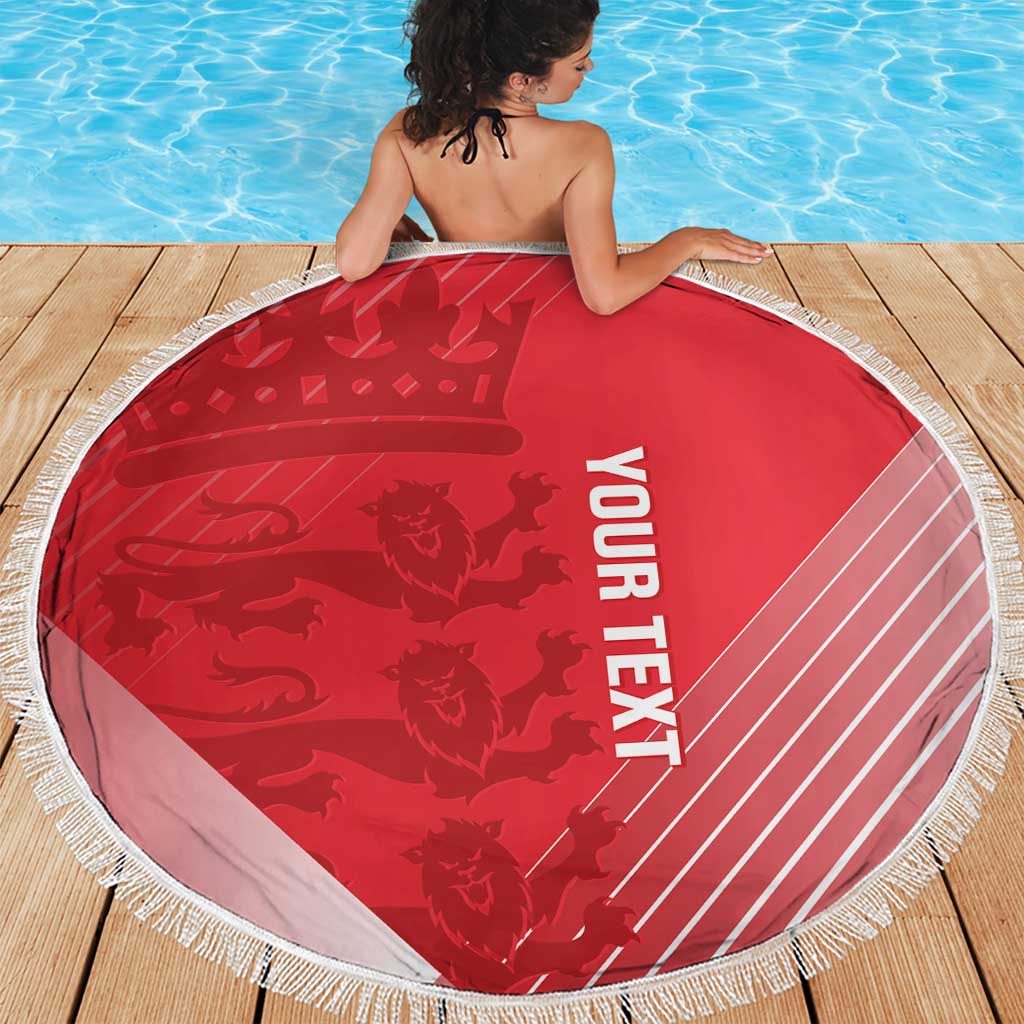 Red round beach blanket with white “YOUR TEXT” and fringed border on deck.