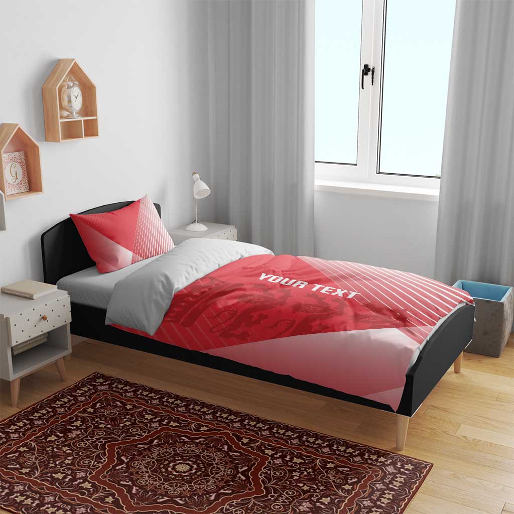 Red duvet cover and two pillowcases with 'YOUR TEXT' and diagonal stripes on bed frame