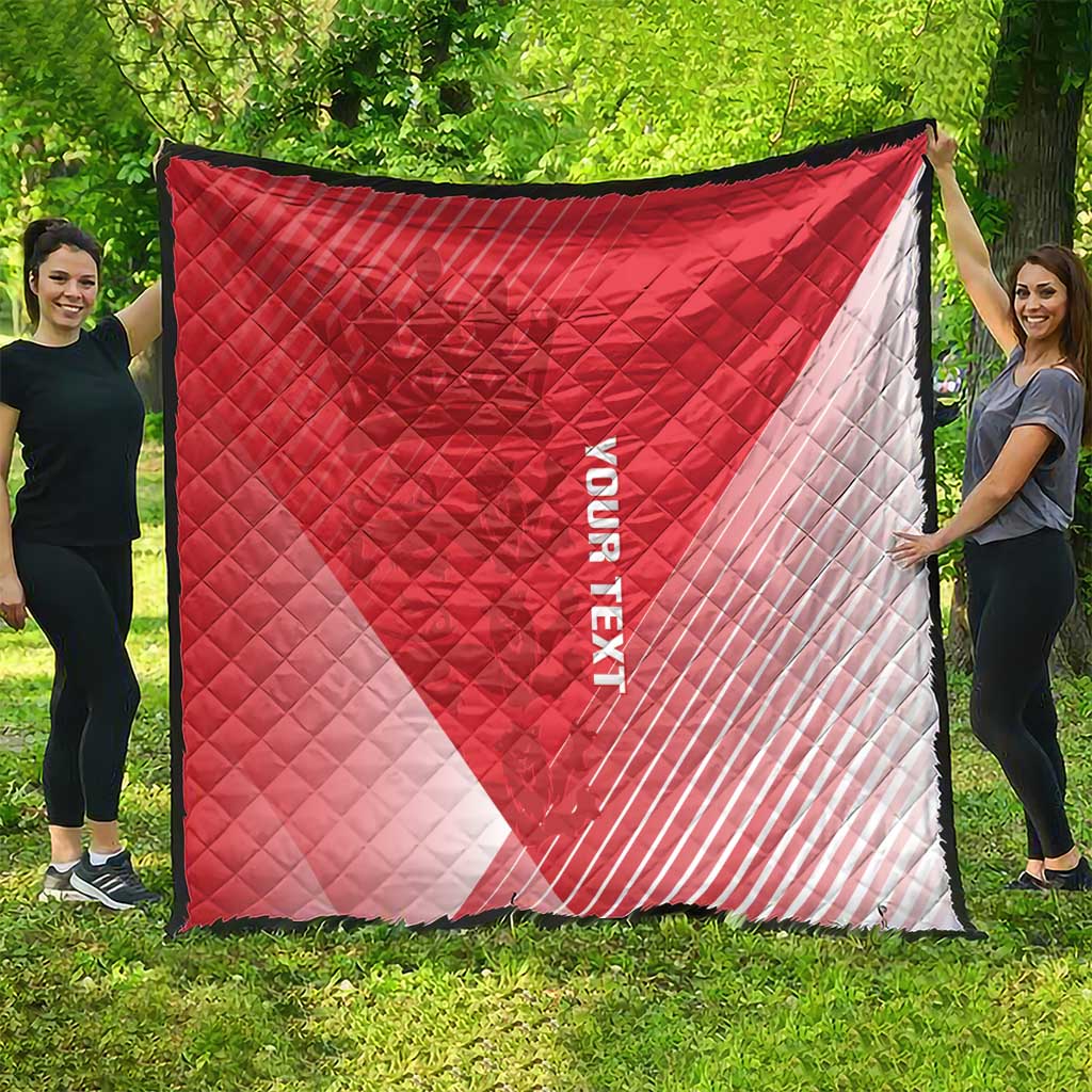 Red and white diagonal quilt blanket with diamond stitching and black border trim