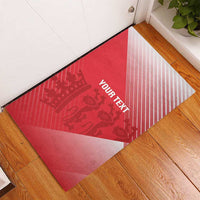 Red rubber doormat with diagonal white stripes, crown-and-animal pattern, custom text
