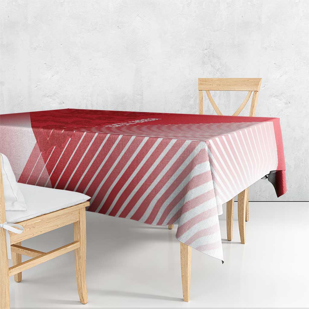 Red tablecloth with pink stripe pattern draped over a dining table and bench.