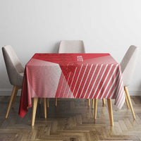 Red and pink geometric striped tablecloth on a rectangular dining table.