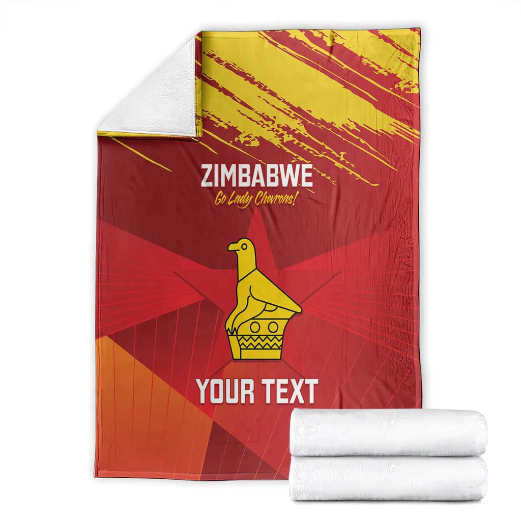Zimbabwe cricket blanket folded with stacked white towels, red with yellow emblem and “YOUR TEXT”
