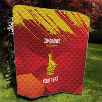 Custom Zimbabwe cricket quilt laid outside, red-and-yellow chevron grunge pattern with bird