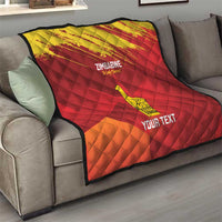 Custom Zimbabwe cricket quilt on sofa, red-and-yellow chevron grunge design with bird