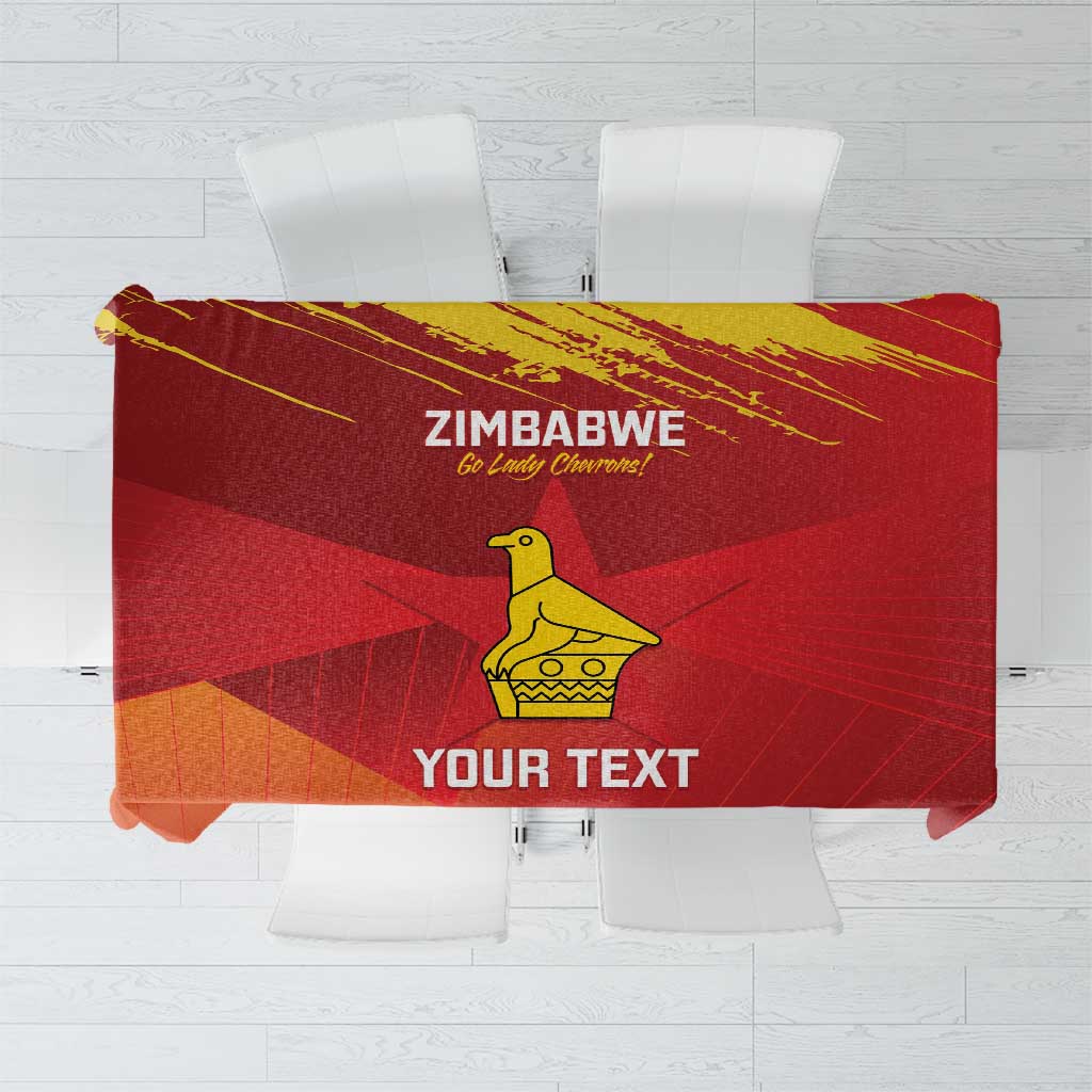 Red tablecloth close-up: Zimbabwe text, yellow emblem, and “YOUR TEXT” area