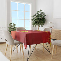 Red tablecloth with yellow graphic and custom text, covering a dining table