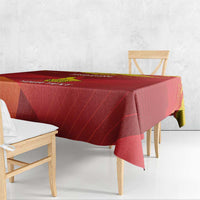 Red tablecloth with yellow emblem and custom text, draped over a dining table