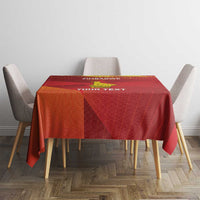 Red tablecloth with yellow Zimbabwe-style graphic and custom text across the tabletop