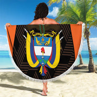 Round black beach blanket with white fringe, orange edge, and Colombia crest artwork